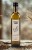 Szklana_butelka_oleju_czosnkowego_100ml_na_stole_obok_ząbków_czosnku